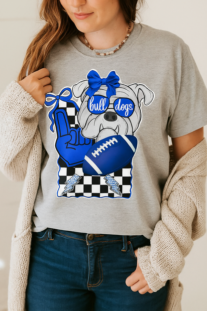 Person wearing a gray t-shirt with a bulldog graphic and 'bulldogs' text, holding a beige cardigan.