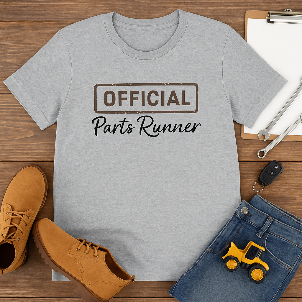 Gray t-shirt with 'OFFICIAL Parts Runner' text on a wooden surface with shoes and jeans.