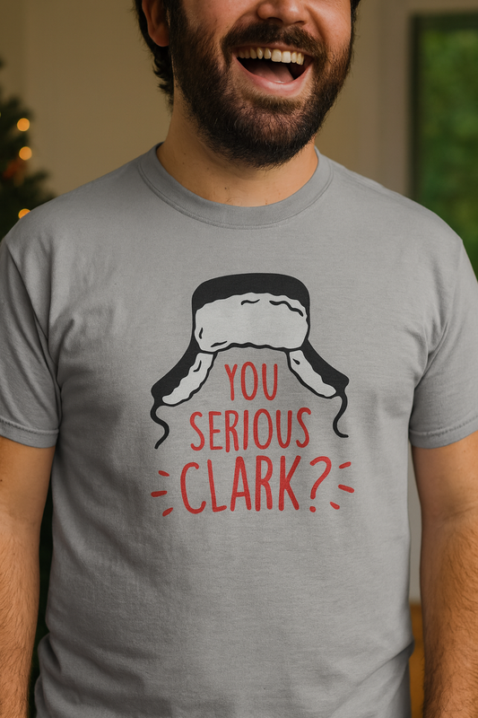 Person wearing a gray t-shirt with a Christmas-themed graphic and text.