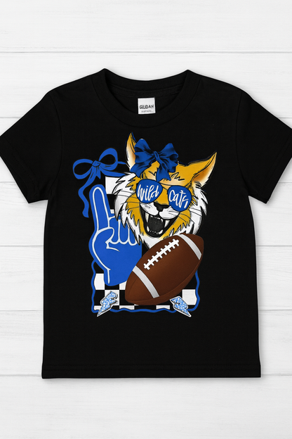 Black t-shirt with a graphic of a wildcat holding a football, blue and yellow colors, on a white wooden background.